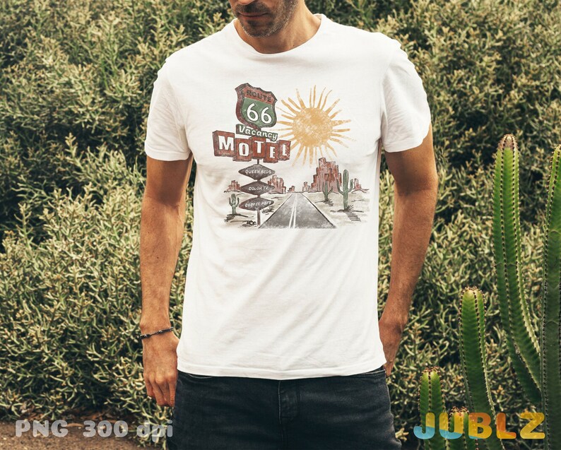 May include: White t-shirt with a vintage-style illustration of a desert road sign that reads "Route 66 Vacancy Motel".