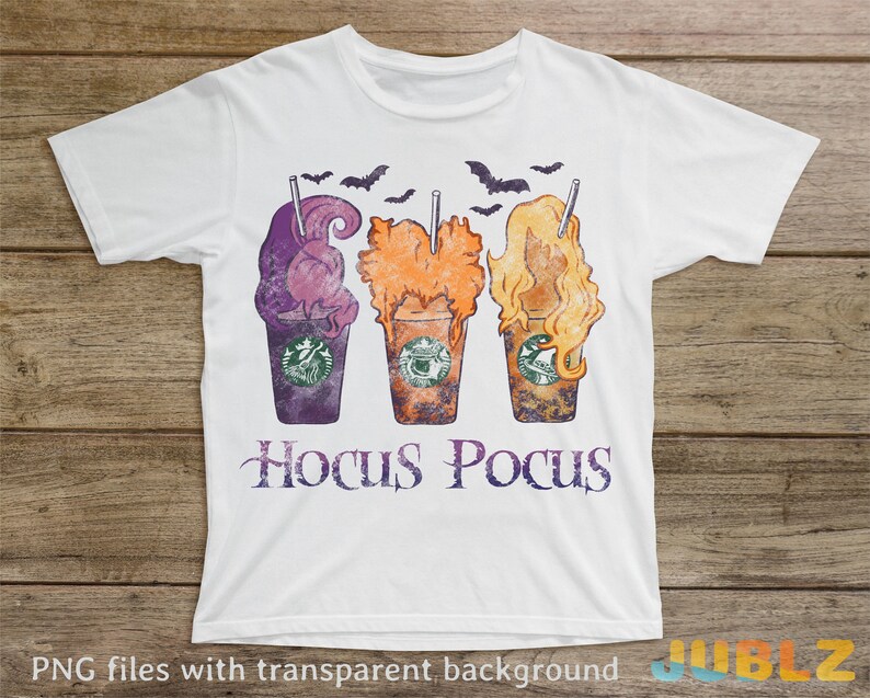 May include: White t-shirt featuring a design of three Halloween-themed coffee cups with the text "Hocus Pocus" below.