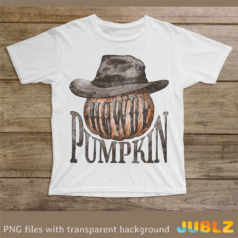 May include: White t-shirt with a graphic of a pumpkin wearing a cowboy hat. The text "Howdy Pumpkin" is printed below the pumpkin.