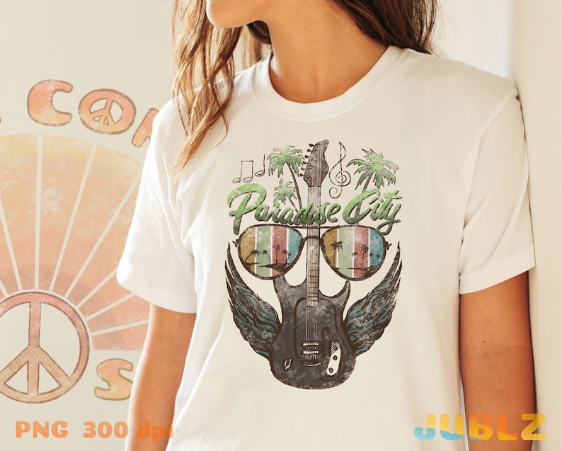 May include: White t-shirt with a graphic of a guitar with sunglasses and palm trees. The text "Paradise City" is above the guitar.