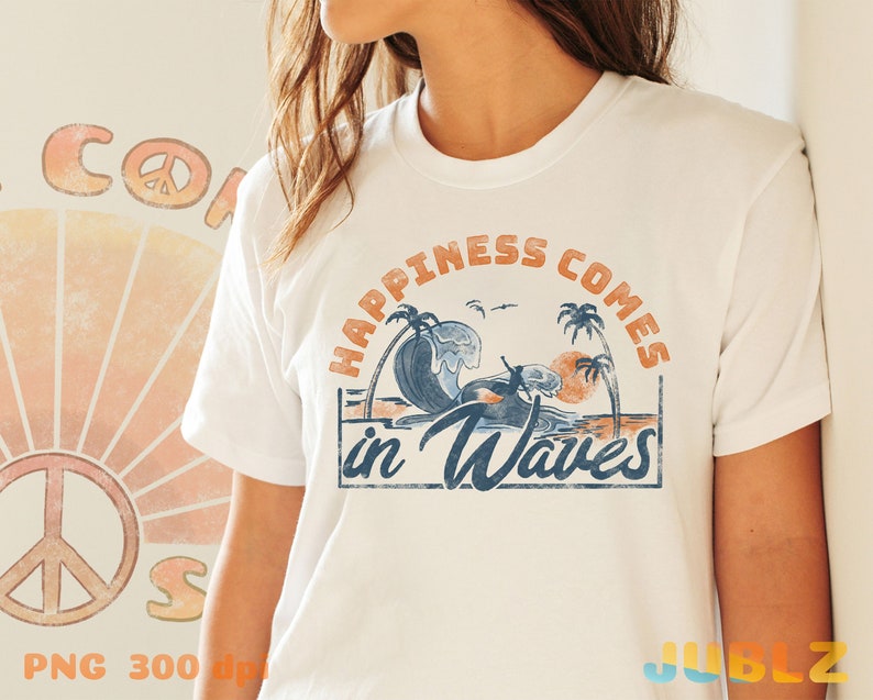 May include: White t-shirt with a vintage-style graphic that says "Happiness comes in waves". The graphic features a sunset, palm trees, and a surfer riding a wave.