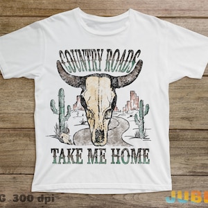May include: White t-shirt with a vintage-style graphic of a skull with horns, cacti, and a road. The text "COUNTRY ROADS TAKE ME HOME" is printed below the graphic.