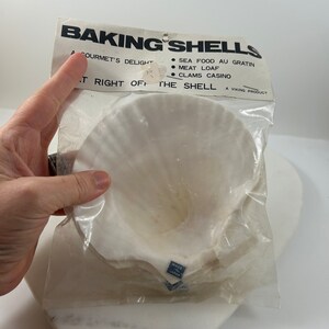 May include: A pack of white baking shells, labelled "Baking Shells, A Gourmet's Delight, Right Off The Shell, A Viking Product". The pack lists uses for the shells, including "Sea Food Au Gratin, Meat Loaf, Clams Casino".