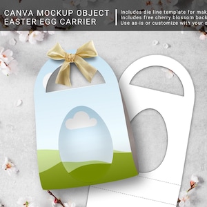 May include: A white cardboard Easter egg carrier with a die-cut window for an egg. The carrier has a handle and a green and blue landscape design. The carrier is decorated with a gold ribbon bow.