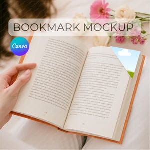 May include: Open book with a bookmark featuring a sky and cloud design. The book has an orange cover and is open to a page with text. The words "BOOKMARK MOCKUP" are displayed above the book.
