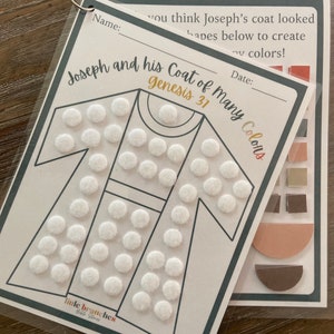 May include: A printable activity sheet for children featuring a coat with white circles and the text "Joseph and his Coat of Many Colors Genesis 31".
