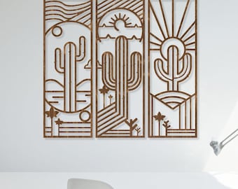 May include: Three wooden wall panels with a geometric design of a desert landscape featuring a cactus, sun, and mountains. The panels are mounted on a white wall above a white desk with a wooden chair.