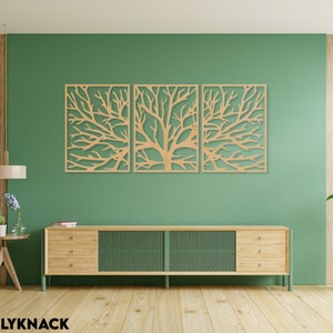 May include: Three-panel wooden wall art featuring a tree branch design. The artwork is made of light-colored wood and is mounted on a green wall. The room also includes a wooden cabinet, a side table, and a potted plant.