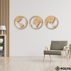 May include: Three wooden wall decor pieces shaped like the Earth, each showing a different continent. The pieces are light brown and are mounted on a white wall.