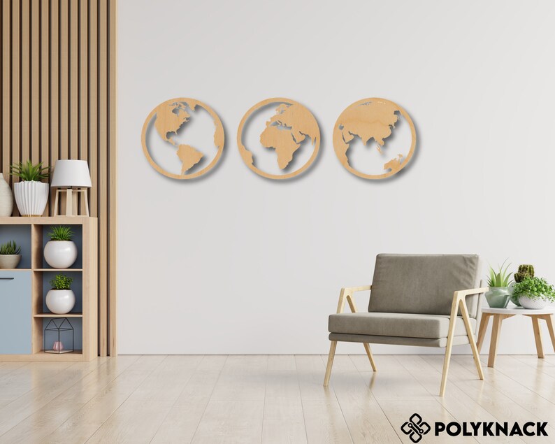 May include: Three wooden wall decor pieces shaped like the Earth, each showing a different continent. The pieces are light brown and are mounted on a white wall.
