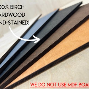 May include: Close-up of five different wood panels, each stained a different color. The panels are stacked on top of each other, with the lightest color on top and the darkest color on the bottom. The text "100% BIRCH HARDWOOD HAND-STAINED!" is visible at the top of the image. The text "WE DO NOT USE MDF BOARD" is visible at the bottom of the image.
