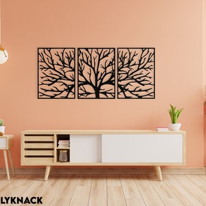 May include: A triptych of black metal tree branch wall art. Each panel is rectangular with a detailed cutout design of a tree's branches. The artwork is mounted on a peach-colored wall above a wooden cabinet.