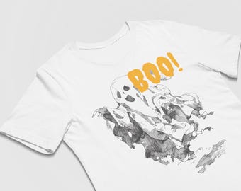 May include: White t-shirt featuring a black and white ghost illustration with the word "BOO!" in orange. The ghost design has a sketched appearance, and the shirt is made of a soft material.