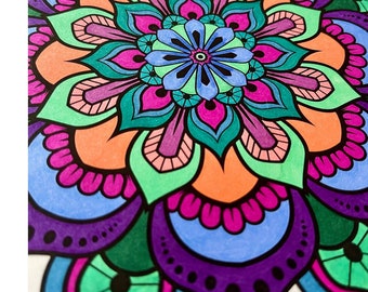 May include: A colorful mandala design with intricate details in shades of pink, orange, green, blue, and purple. The design features a central flower with multiple layers of petals.
