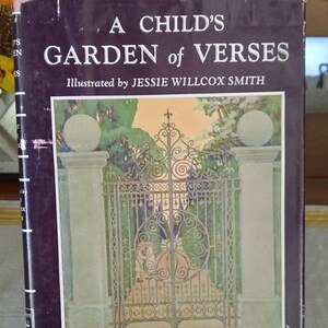 May include: A vintage book titled "A Child's Garden of Verses" by Robert Louis Stevenson. The cover features an illustration of a decorative wrought iron gate. The book has a dark purple cover with white text.