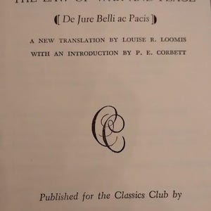 May include: A book page with the title "HUGO GROTIUS" and "THE LAW OF WAR AND PEACE". The text includes "De Jure Belli ac Pacis", a new translation by Louise R. Loomis, and an introduction by P. E. Corbett. Published by Walter J. Black.