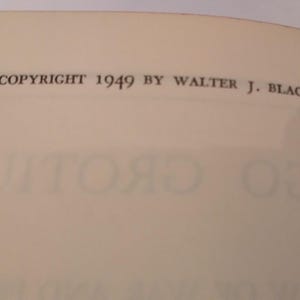 May include: A close-up of a book page with the text "COPYRIGHT 1949 BY WALTER J. BLACK, INC." printed in black. The page is off-white, and the text is centered at the top.