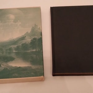 May include: A vintage hardcover book with a green and white dust jacket featuring a landscape painting of a river, mountains, and trees. The book is closed and the spine is visible.
