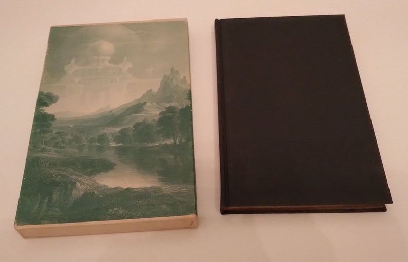 May include: A vintage hardcover book with a green and white dust jacket featuring a landscape painting of a river, mountains, and trees. The book is closed and the spine is visible.