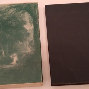 May include: A vintage book with a green and white dust jacket featuring a painting of a woman in a white dress standing in a forest. The book has a black cover.