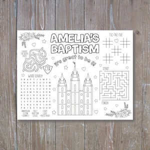 May include: Black and white activity sheet for Amelia's Baptism, featuring a word search, maze, tic-tac-toe, and a drawing of a temple. The text includes "Choose the Right Path" and "It's great to be 8!"