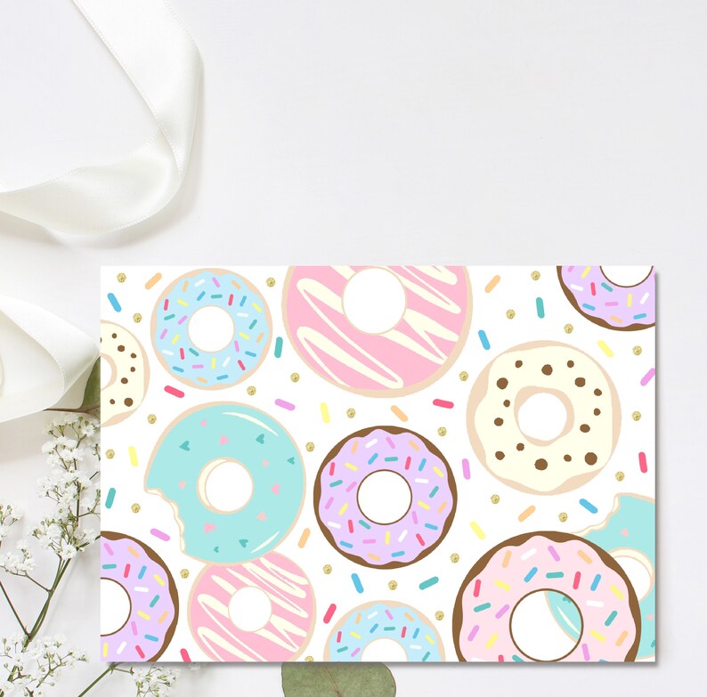 May include: A white background with a pattern of colorful donuts with sprinkles and frosting. The donuts are arranged in a random pattern and are surrounded by gold glitter.