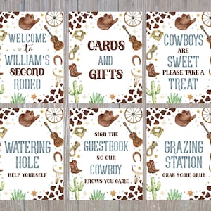 May include: Six cowboy-themed signs with watercolour illustrations. Each sign features a brown cowboy hat, guitar, horseshoe, and cactus. Text includes "Welcome to William's Second Rodeo" and "Cards and Gifts."