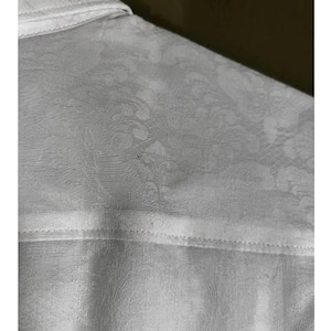 May include: A set of three ceramic mugs with a speckled, matte finish. The mugs are in shades of cream, light gray, and dark gray. Each mug has a simple, minimalist design, perfect for coffee or tea.