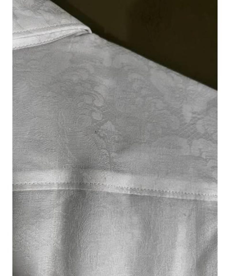 May include: A set of three ceramic mugs with a speckled, matte finish. The mugs are in shades of cream, light gray, and dark gray. Each mug has a simple, minimalist design, perfect for coffee or tea.