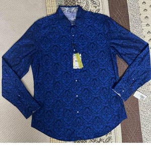 May include: A long-sleeved button-down shirt in a deep blue hue, adorned with a dark blue floral pattern. The shirt features a classic collar and cuffs with a contrasting design. A tag is attached, indicating the garment's brand and size.