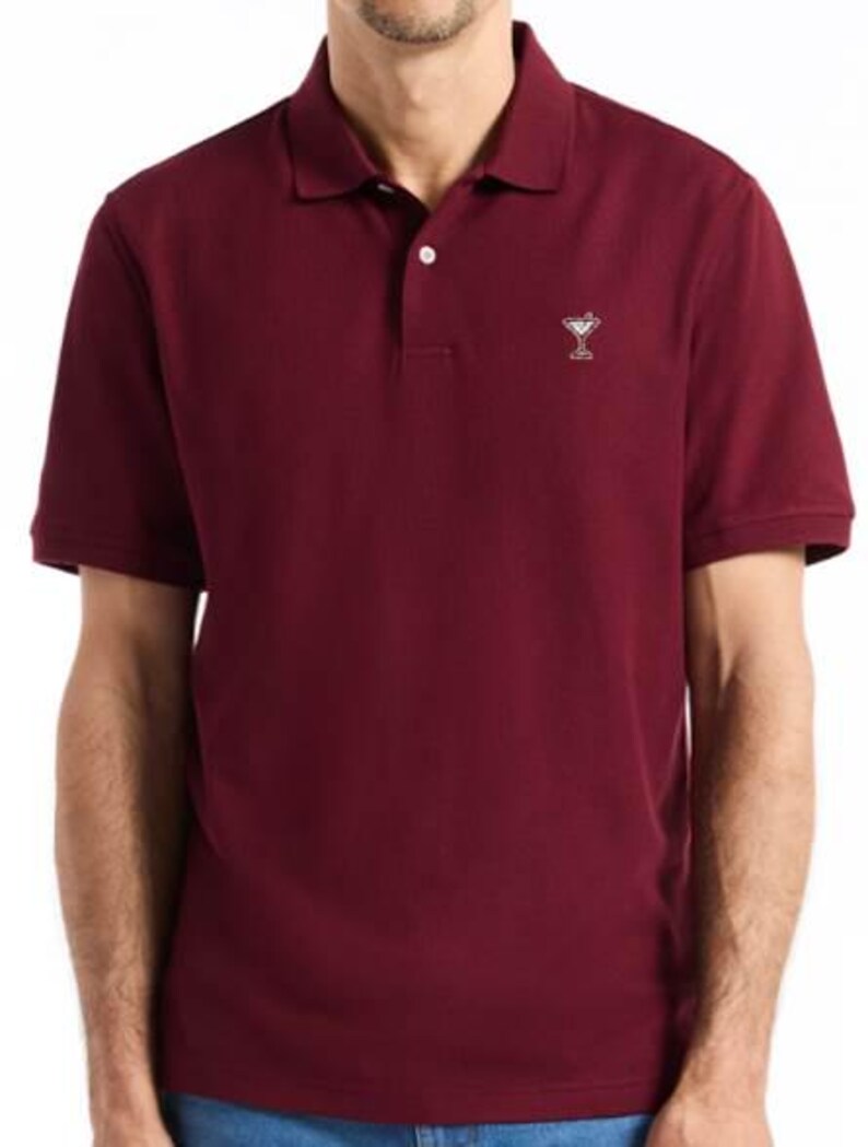 May include: A white ceramic mug with a black handle and the text "But First, Coffee" in a black, bold font. The mug is on a white surface.