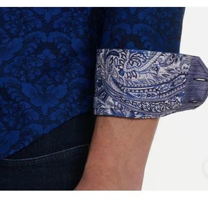 May include: A set of three ceramic mugs with a speckled, matte finish. The mugs are in shades of cream, light brown, and dark brown. Each mug has a simple, minimalist design, perfect for coffee or tea.