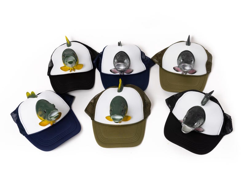 May include: Six different trucker hats with a variety of fish designs. The hats are all black, white, and green with a mesh back.