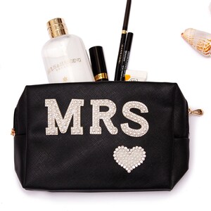 May include: Black zippered makeup bag with a white rhinestone heart and the word "MRS" in white rhinestones.