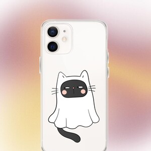May include: A clear phone case with a black cat wearing a white ghost costume. The cat has pink cheeks and a grumpy expression.