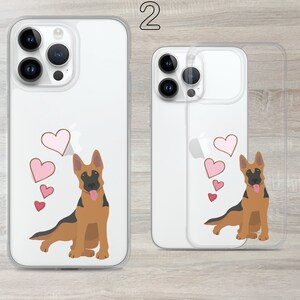 May include: Two clear phone cases with a German Shepherd dog design. The dog is brown and black with pink hearts around it. The cases are for an iPhone 13 Pro Max.