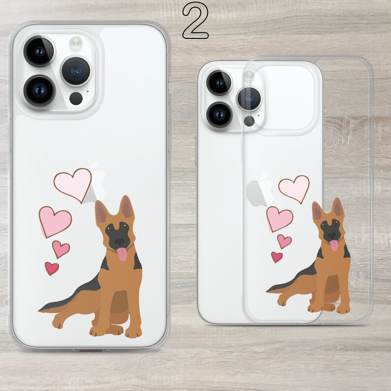 May include: Two clear phone cases with a German Shepherd dog design. The dog is brown and black with pink hearts around it. The cases are for an iPhone 13 Pro Max.