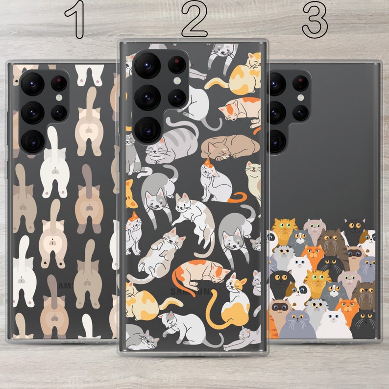 May include: Three clear phone cases with a black background and a pattern of cartoon cats in various poses. The cases are labelled 1, 2, and 3.