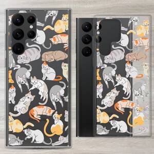 May include: A clear phone case with a black background and a pattern of colourful cats. The case is designed for a Samsung Galaxy phone.