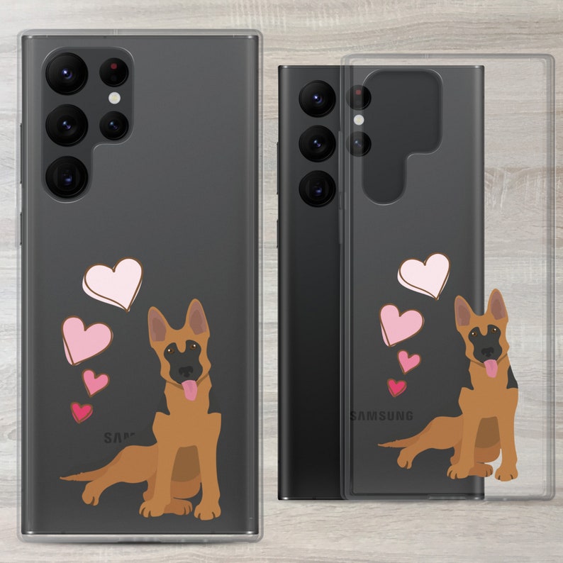 May include: A clear phone case with a black Samsung Galaxy phone inside. The case has a design of a German Shepherd dog with pink hearts.