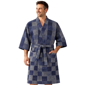 May include: A blue and gray patterned robe with a shawl collar and a matching belt. The robe has a checkered design with a wavy pattern within each square. It features short sleeves and pockets. The person is wearing the robe.