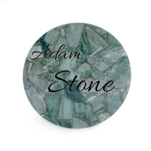 May include: Round, green stone coaster with a mosaic pattern. The coaster has the words "Adam Stone" in a black script font. The stone has a mix of light and dark green hues.
