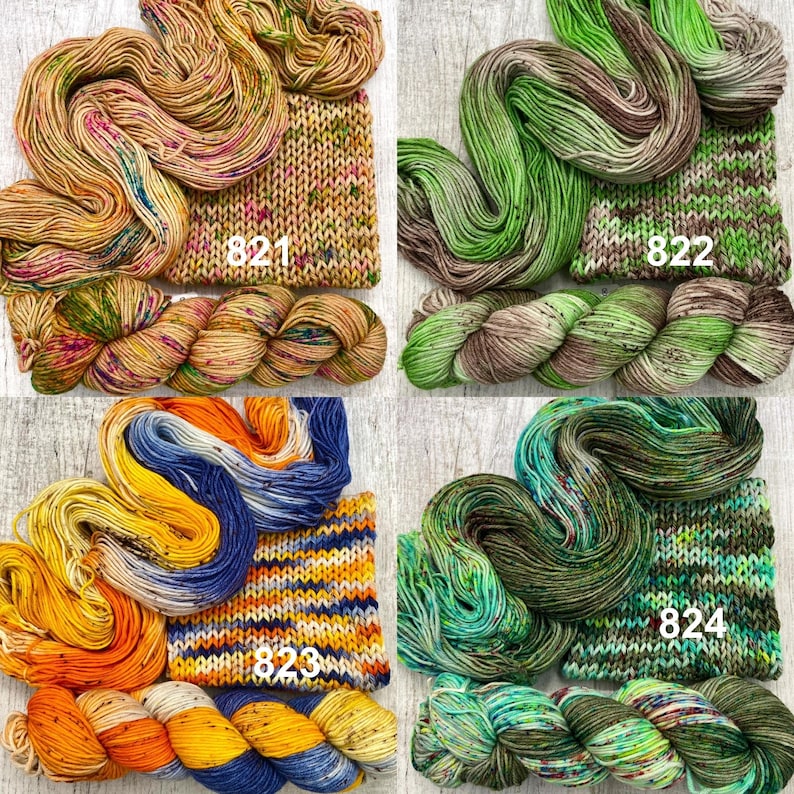 May include: Four sets of hand-dyed yarn skeins paired with matching knitted swatches. The sets are labelled 821 in yellow and pink, 822 in green and brown, 823 in orange, yellow, and blue, and 824 in various shades of green and brown.