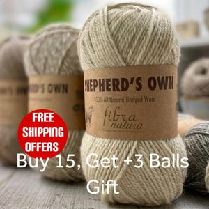 May include: A ball of light beige, undyed wool yarn with a brown paper label reading Shepherd's Own 100% All Natural Undyed Wool and Fibra Natura. The yarn has a thick, twisted texture, and several other balls of yarn in various neutral shades are visible.