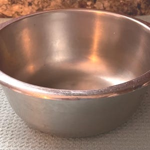 May include: A rustic wooden sign with the text "Welcome to our home" in white lettering. The sign features a distressed finish and a simple, inviting design, perfect for a front porch or entryway.