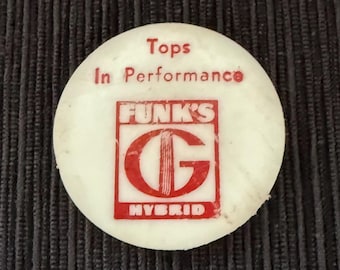 May include: A circular, off-white item with red lettering and a logo. The text says "Tops In Performance" and "FUNK'S HYBRID". The logo is a red "G" with vertical lines inside a red square.