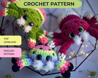 May include: Three plush crochet spider toys with large black eyes and white fuzzy accents. One is green with pink tips, one is magenta with white tips, and one is rainbow-colored with black tips. Text reads CROCHET PATTERN, PDF DOWNLOAD, ENGLISH PATTERN.