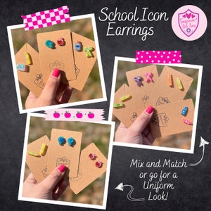 May include: Four cards with different pairs of earrings on each. The earrings are school themed and include images of apples, pencils, crayons, and a ruler. The cards are brown and have the text "Tennessee Girl Bang" on them. The text "School Icon Earrings" is at the top of the image. The text "Mix and Match or go for a Uniform Look!" is at the bottom of the image.