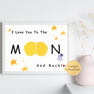 May include: A white framed print with the text "I Love You To The Moon And Back!" in black. The word "Moon" is illustrated with two yellow moons. There are yellow stars scattered around the text. An astronaut is illustrated next to the word "Back!" with a red heart.