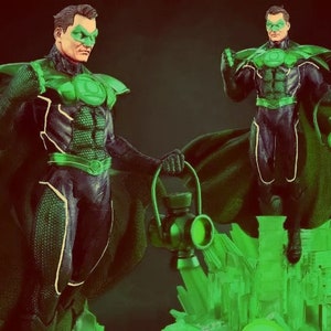 May include: Green Lantern action figure with a green cape and a green lantern in his hand. The figure is standing on a green base with a cityscape design.